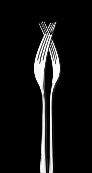 Twee gekruiste zilveren vorken — Stockfoto
