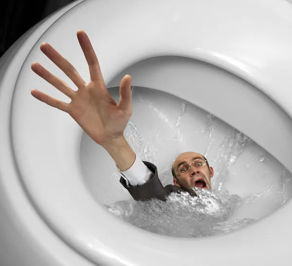 Empresário afundando em vaso sanitário — Fotografia de Stock