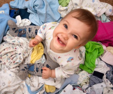 Baby in heap of wear clipart