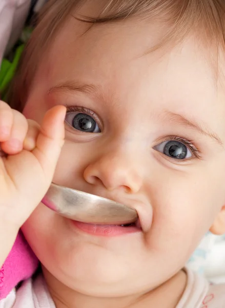 Happy baby girl with spoon — Stock Photo, Image