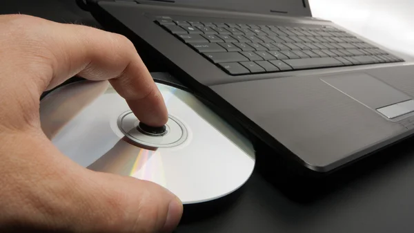 Loading disk into laptop — Stock Photo, Image