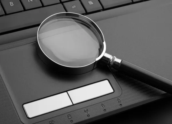 stock image Magnifying glass on laptop