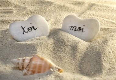 French you and me hearts of pebbles in the sand clipart