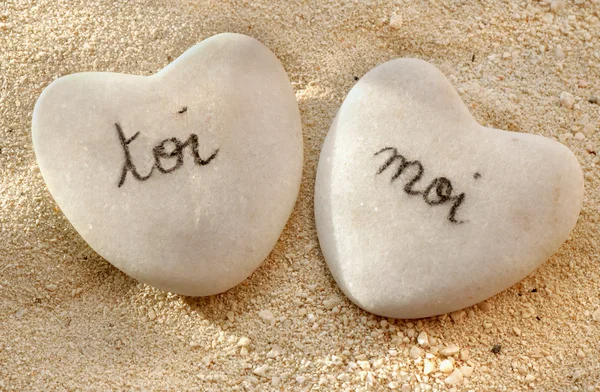 stock image French you and me hearts of pebbles in the sand