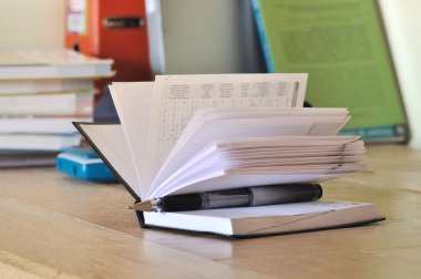 Calendar on the desk of a student clipart