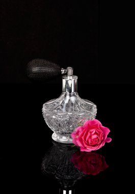 Luxurious perfume bottle atomizer with flower blossom clipart