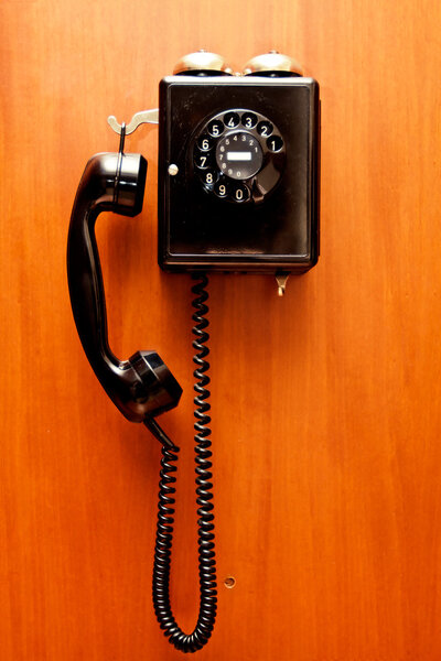 Phone hangs on a wall, background