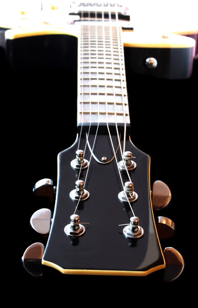 Close up detail of antique semi-hollow body electric guitar with sunburst finish.