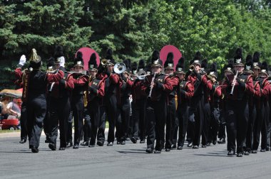 Dover-Eyota High School Marching Band Performing in a Parade clipart