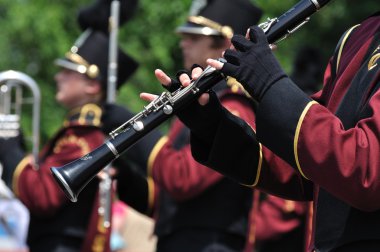 Dover-Eyota High School Marching Band Performer Playing Clarinet in Parade clipart