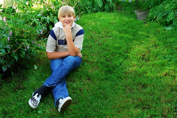 Usměvavý kluk na trávě — Stock fotografie