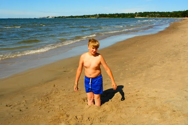 stock image A boy playing on the beach of Baltic Sea