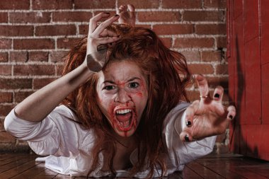 Horror Themed Image With Bleeding Freightened Woman clipart