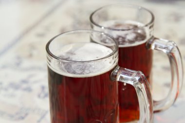 Two beer mugs closeup photo clipart