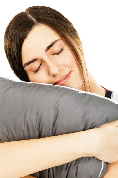 年轻漂亮的女人抱着一个枕头 — 图库照片