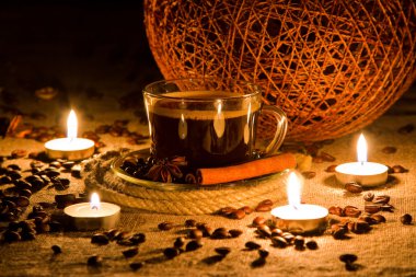 Cup of coffee in natural candle light clipart