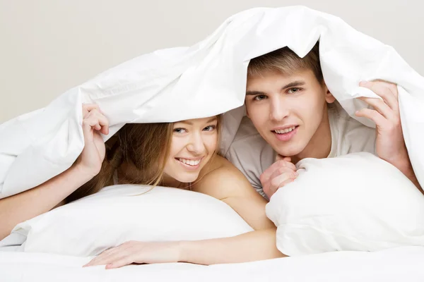 Beautiful couple in bed Royalty Free Stock Photos