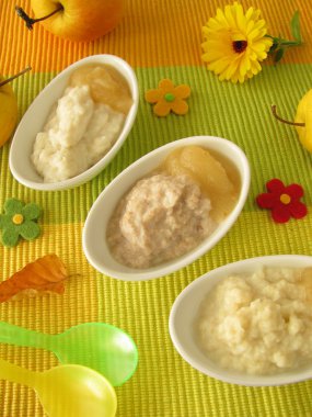 Small bowls with millet porridge, creamed rice and spelt mash for babies an clipart