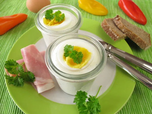 Egg on herb cream cheeses in the glass — Stock Photo, Image