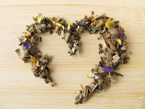 Heart of herbal tea with mountains herbs — Stock Photo, Image
