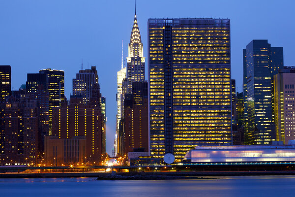 New York City Manhattan midtown skyline over East River at dusk