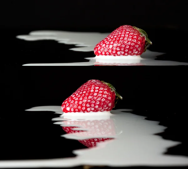 Red strawberries in milk — Stock Photo, Image
