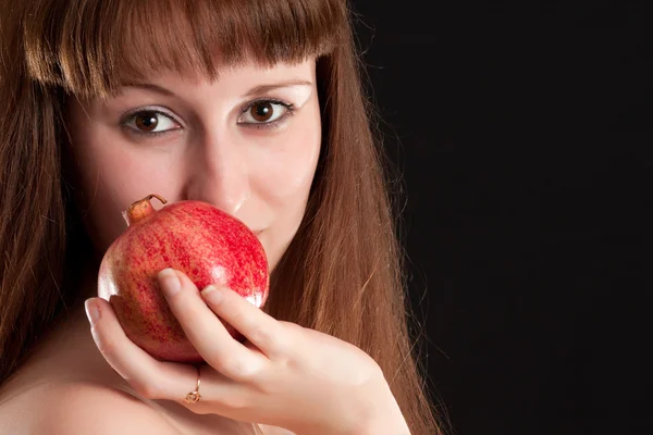 The girl with a red pomegranate — Stock Photo, Image
