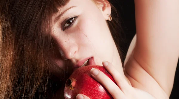 The girl with a red pomegranate — Stock Photo, Image
