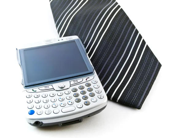 PDA telefone móvel e gravata em fundo branco — Fotografia de Stock