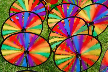 Many colorful windmill toys in the garden clipart