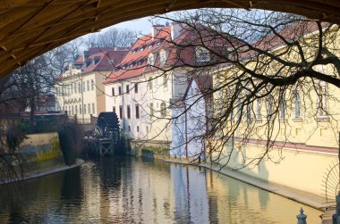 Old water mill on a river in Prague, Czech Republic clipart