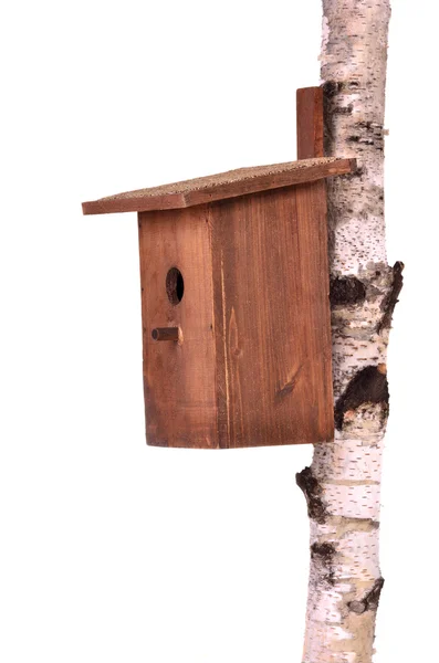 Wooden birdhouse on a stem over white — Stock Photo, Image