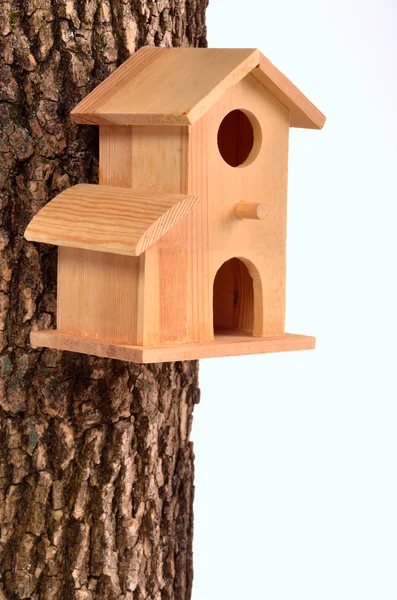 Comfortable starling-house on a tree trunk isolated — Stock Photo, Image