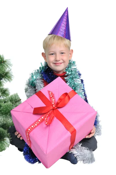 Little boy with Christmas present near new year tree — Stock Photo, Image