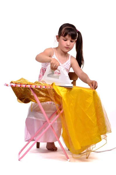 Dangerous housework - little girl ironing her dress — Stock Photo, Image