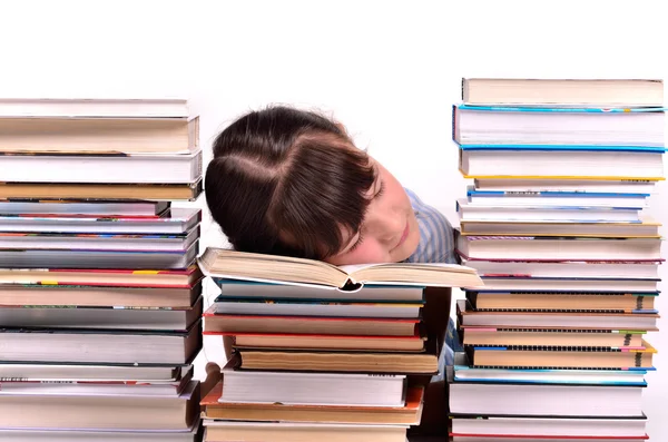 Little gire reading a book sleeping among stacks of books — Stock Photo, Image
