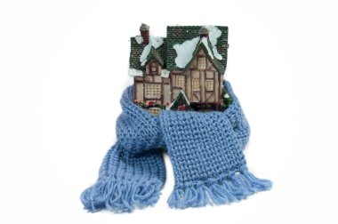 Scarf around a miniature christmas house (conceptual view of protecting or clipart