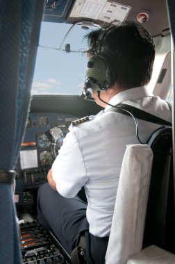 Pilot in a cockpit preparing for Take-off clipart