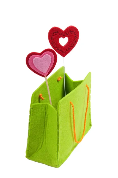 Saco de compras verde com dois corações vermelhos isolados no fundo branco — Fotografia de Stock