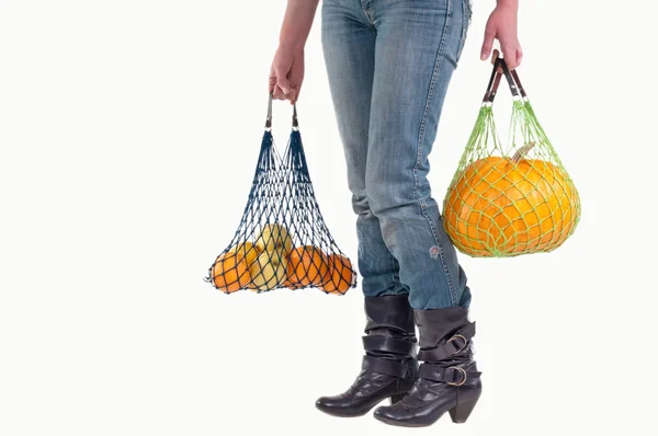 Waist down view of woman with groceries — Stock Photo, Image