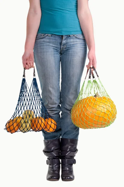 Woman with two fruit grocery bags — Stock Photo, Image