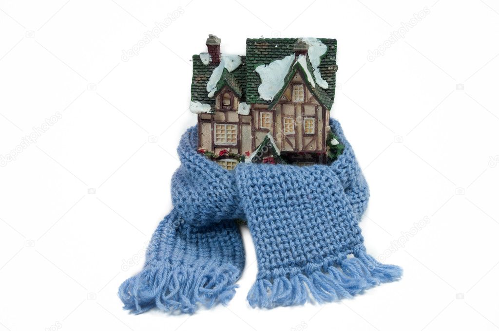 Scarf around a miniature christmas house (conceptual view of protecting or