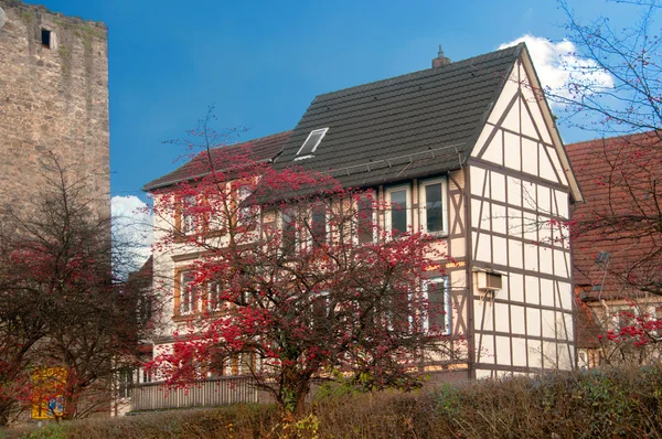 Half timbered house near old castle wall — Stock Photo, Image