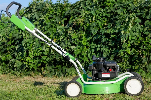 Lawn mower in the garden — Stock Photo, Image