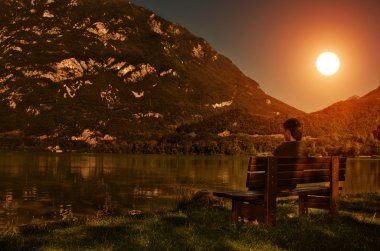 Sunset view - man at the lake clipart
