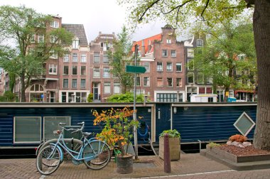Typical Amsterdam's canal with house boat clipart