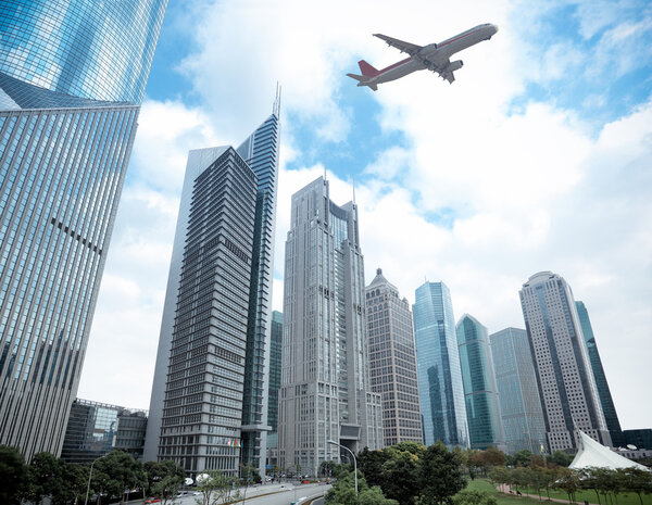Modern building with airplane under the sky in shanghai