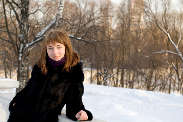 Portrait of a girl walking in park in winter