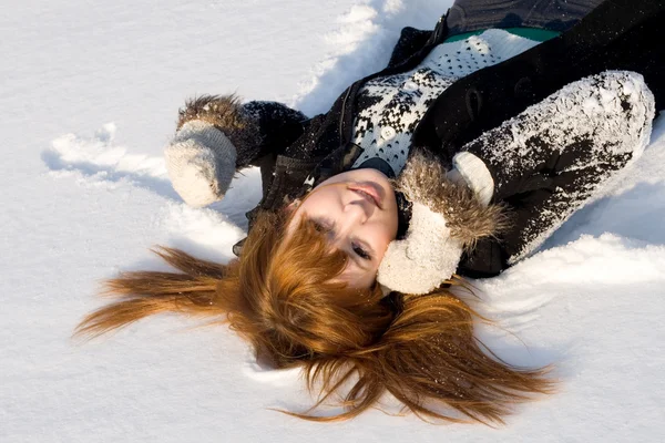 Portrait of a girl lying on snow Royalty Free Stock Images