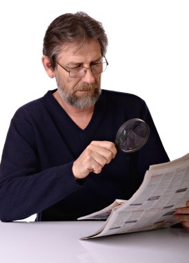 Elderly man reads a newspaper clipart